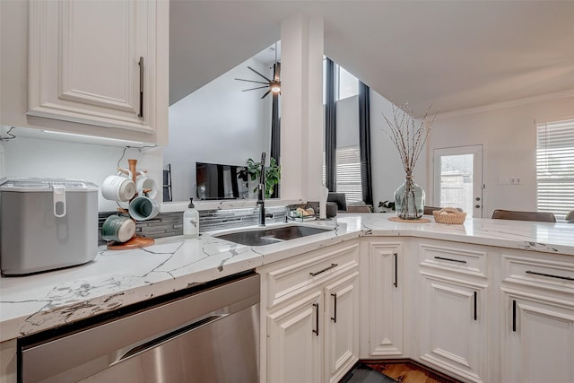 kitchen with sink, light stone counters, white cabinetry, crown molding, and stainless steel dishwasher