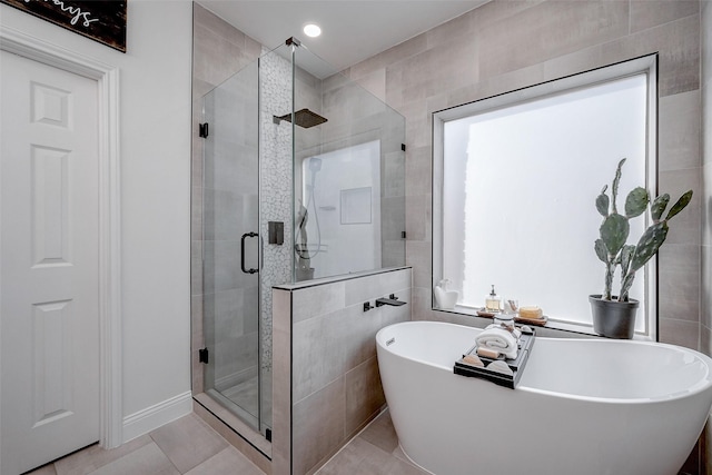 bathroom with tile walls, tile patterned flooring, and independent shower and bath