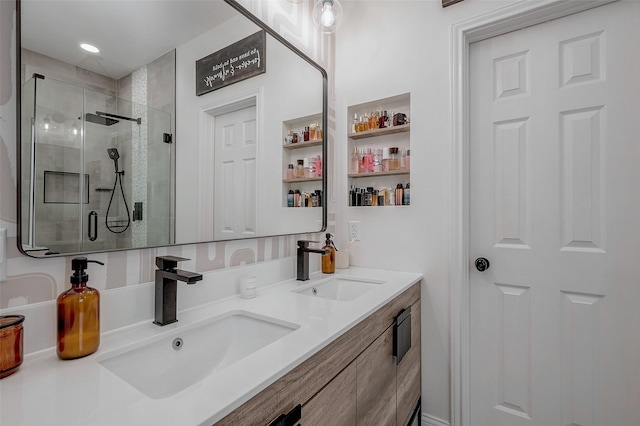 bathroom featuring a shower with shower door and vanity