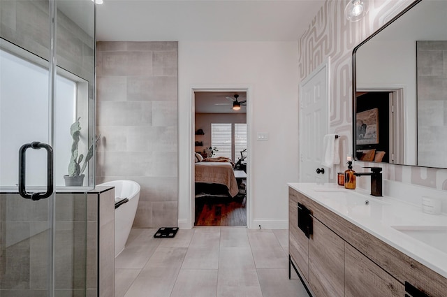 bathroom with tile patterned floors, separate shower and tub, and vanity