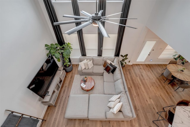 living room featuring hardwood / wood-style floors and ceiling fan