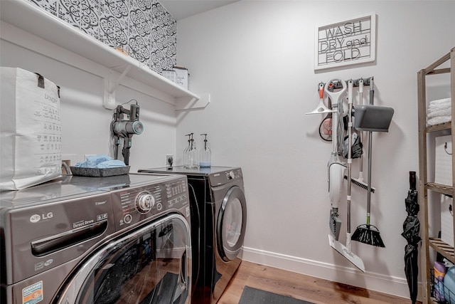 laundry room featuring light wood-type flooring and separate washer and dryer