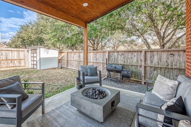 view of patio / terrace featuring area for grilling, a storage shed, and a fire pit