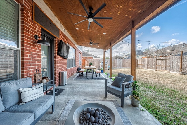 view of patio / terrace featuring an outdoor living space with a fire pit and ceiling fan