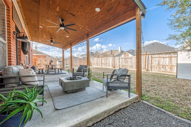 view of patio / terrace featuring ceiling fan and an outdoor living space with a fire pit