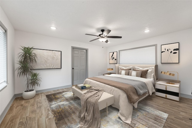 bedroom with hardwood / wood-style floors and ceiling fan