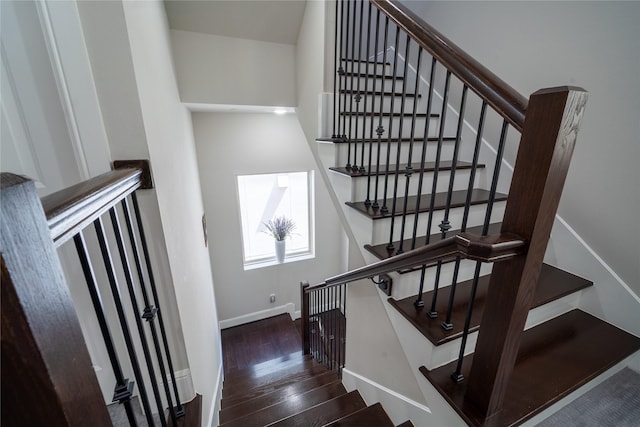 staircase with hardwood / wood-style floors