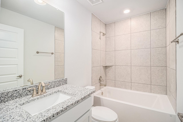 bathroom with visible vents, toilet, vanity, and  shower combination