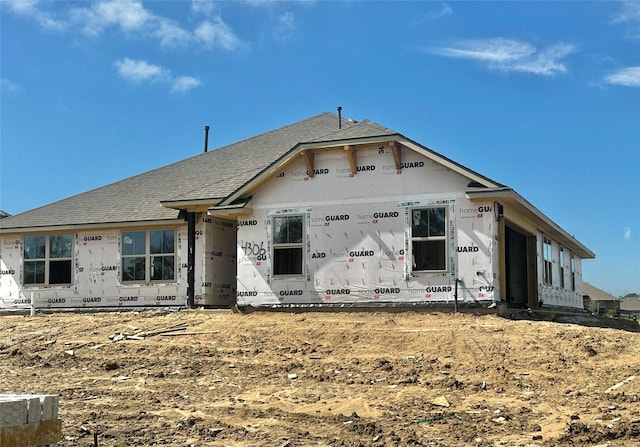 property in mid-construction with roof with shingles