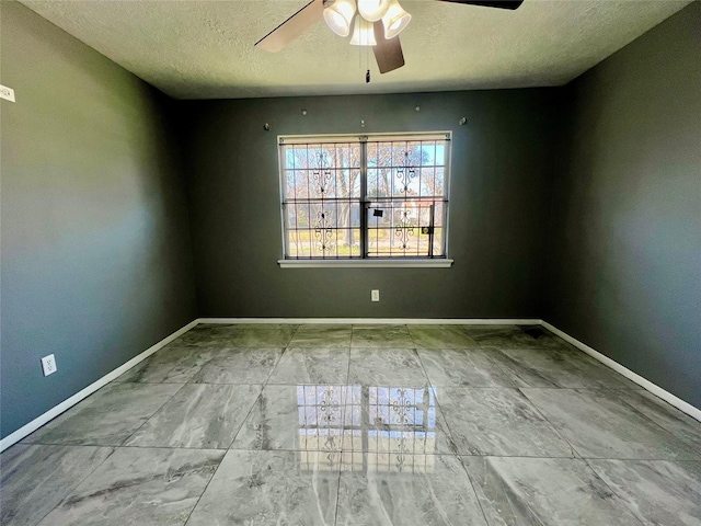 spare room with ceiling fan and a textured ceiling