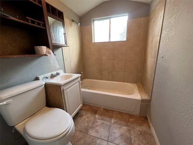 full bathroom featuring lofted ceiling, vanity, toilet, and tiled shower / bath combo