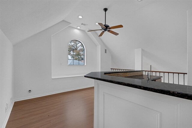 kitchen with lofted ceiling, ceiling fan, dark wood-type flooring, and white cabinets