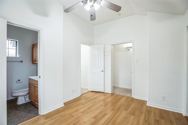 unfurnished bedroom with vaulted ceiling, ceiling fan, ensuite bathroom, and light hardwood / wood-style floors