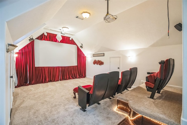 carpeted cinema room featuring vaulted ceiling