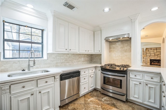 kitchen with extractor fan, sink, white cabinetry, crown molding, and appliances with stainless steel finishes