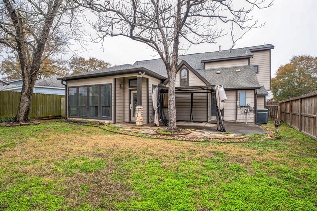 back of house with central AC unit, a patio, and a lawn