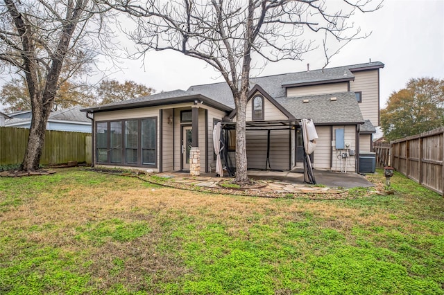 rear view of property featuring a lawn, a patio, and central air condition unit