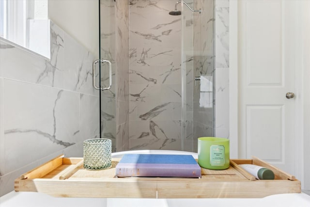 bathroom featuring a marble finish shower