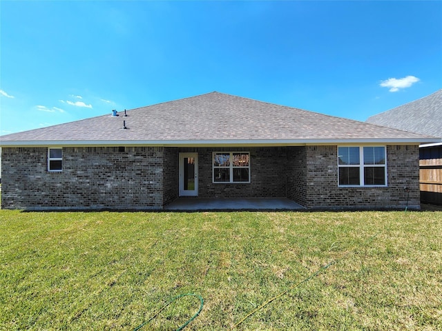 4310 Karam Lndg, Dickinson, TX 77539 - rear view of house featuring brick siding, roof with shingles, a yard, and a patio