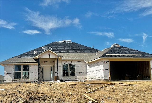 property under construction with a garage and a shingled roof