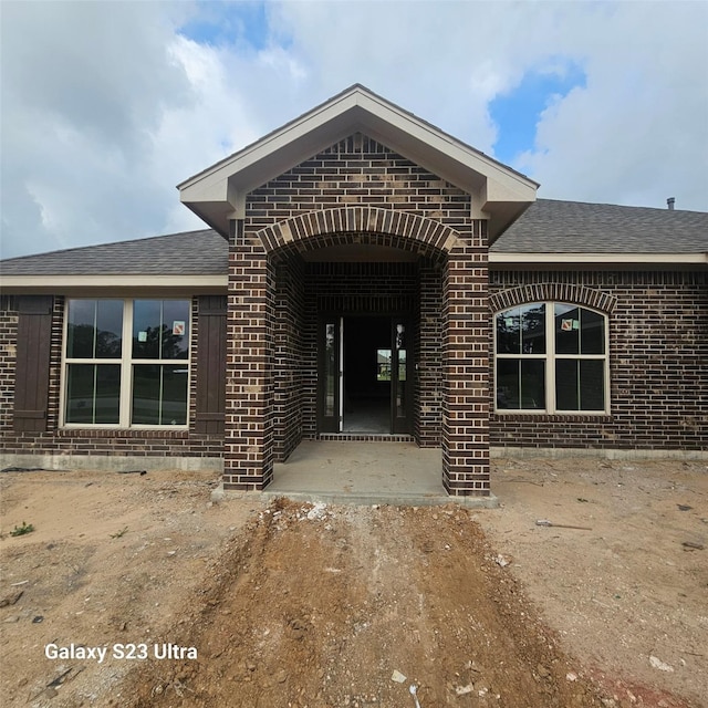 4310 Karam Lndg, Dickinson, TX 77539 - entrance to property featuring brick siding and a shingled roof