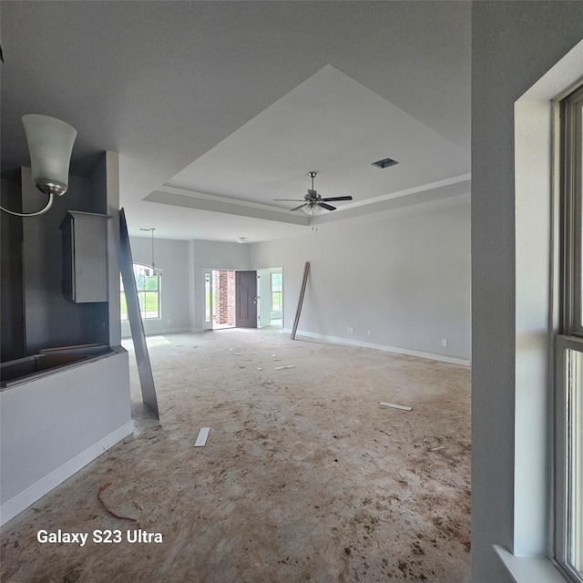 4310 Karam Lndg, Dickinson, TX 77539 - unfurnished living room featuring a raised ceiling, baseboards, and ceiling fan