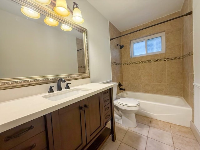 full bathroom featuring tile patterned flooring, vanity, toilet, and tiled shower / bath