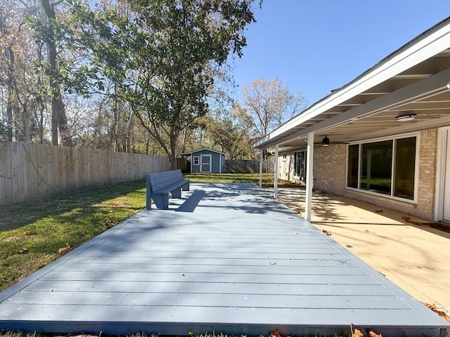 deck with a storage unit and a yard