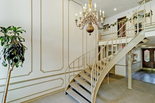 staircase featuring carpet