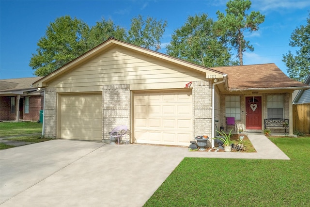 single story home with a garage and a front lawn