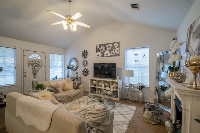 living room with lofted ceiling, ceiling fan, and carpet flooring