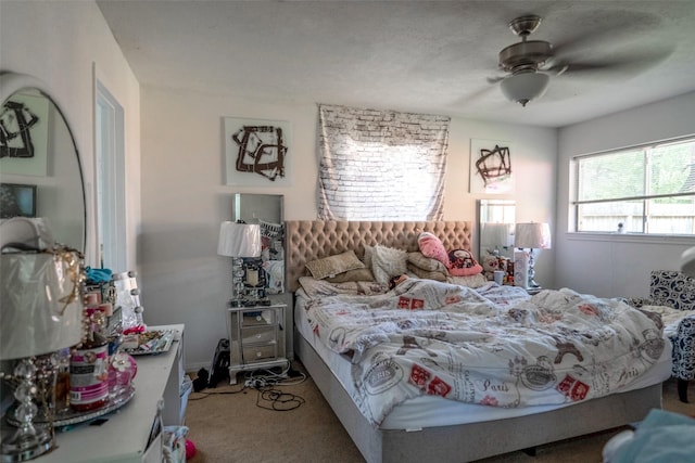 bedroom featuring ceiling fan and carpet