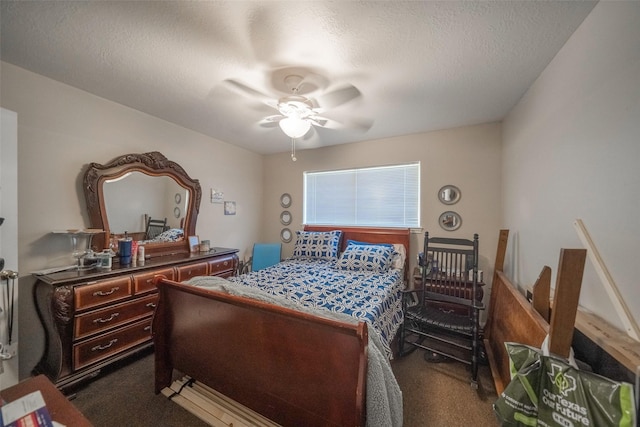 carpeted bedroom featuring ceiling fan and a textured ceiling