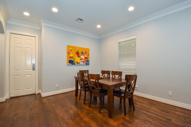 dining room featuring dark wood-type flooring and crown molding