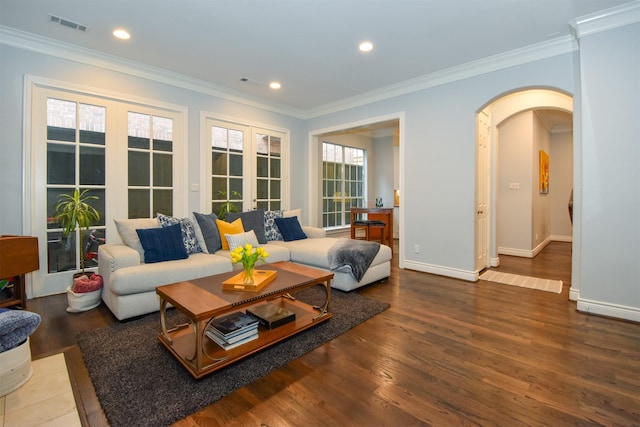 living room featuring ornamental molding, hardwood / wood-style floors, and french doors