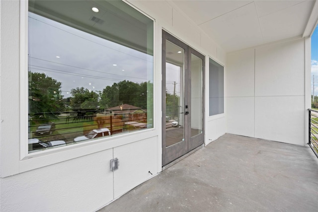 unfurnished sunroom with french doors