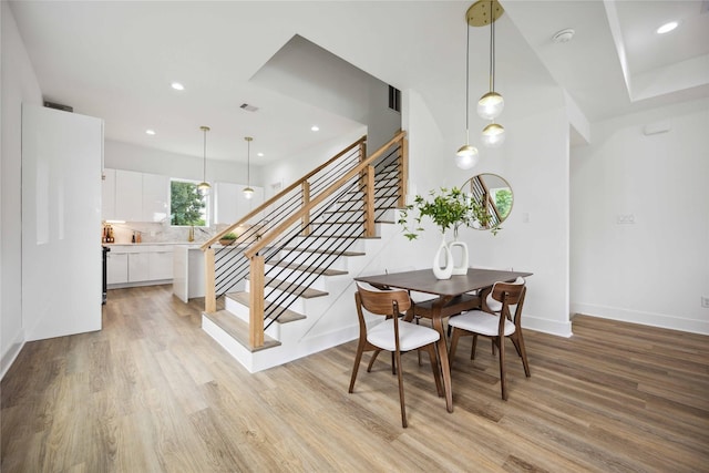 dining area featuring sink and light hardwood / wood-style floors