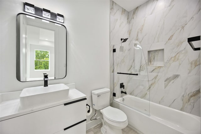 full bathroom with tiled shower / bath combo, vanity, and toilet