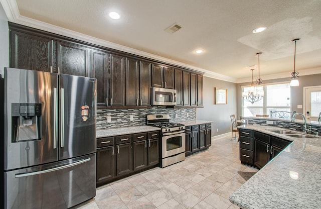 kitchen with sink, dark brown cabinets, ornamental molding, pendant lighting, and stainless steel appliances