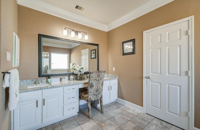 bathroom featuring crown molding and vanity