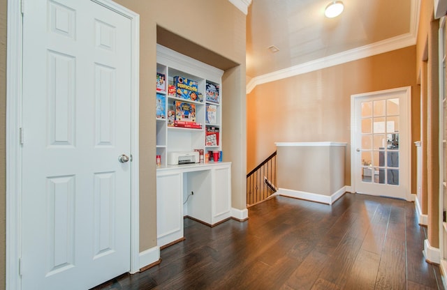 interior space featuring dark wood-type flooring and ornamental molding