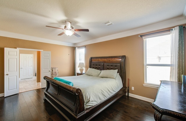 bedroom featuring dark hardwood / wood-style flooring, crown molding, a textured ceiling, and ceiling fan