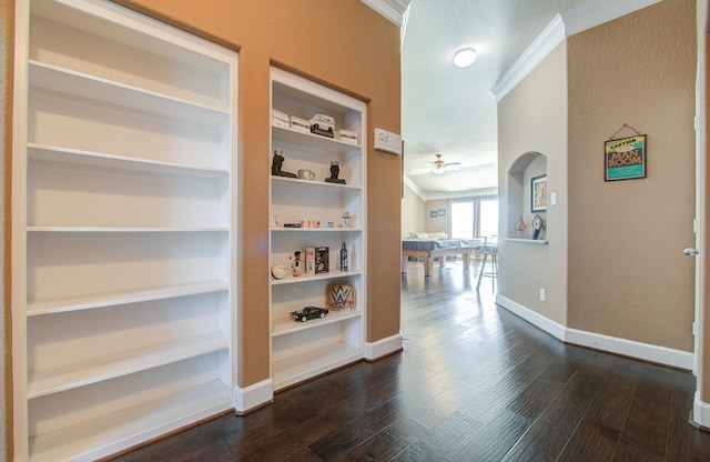 hall featuring crown molding, dark hardwood / wood-style floors, and built in features