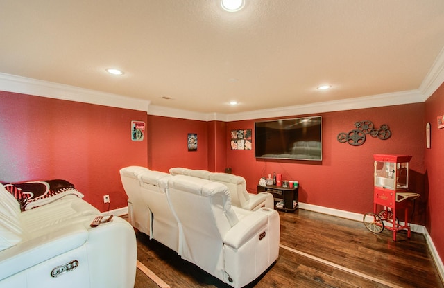 home theater room with dark hardwood / wood-style flooring and ornamental molding