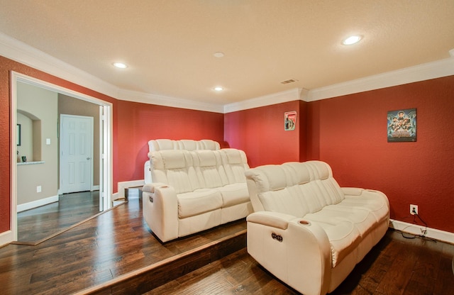 cinema room with crown molding and dark hardwood / wood-style flooring