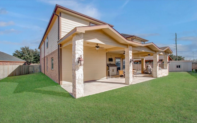 rear view of house with a yard, a patio area, and ceiling fan