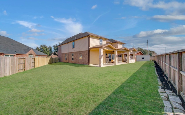 rear view of house with a yard and a patio area