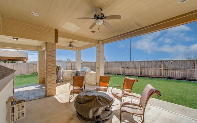 view of patio with area for grilling and ceiling fan