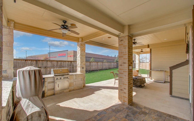 view of patio featuring a grill, area for grilling, and ceiling fan