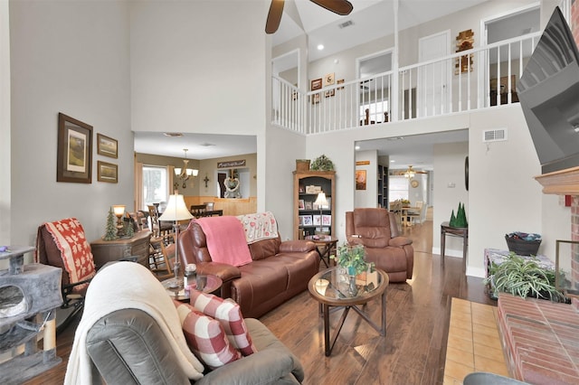 living room featuring hardwood / wood-style flooring, a brick fireplace, and ceiling fan